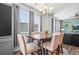 Dining area with a view of the house's exterior, dining table and decorative chandelier at 4604 Copeland Cir # 101, Highlands Ranch, CO 80126