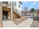 Street view of a condo showing its exterior entrance, stairway, and rock garden at 4604 Copeland Cir # 101, Highlands Ranch, CO 80126