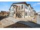 Exterior view of a two-story townhome featuring modern architectural design and manicured landscaping at 4604 Copeland Cir # 101, Highlands Ranch, CO 80126