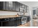 Kitchen with dark wood cabinets, stainless steel oven, and granite countertops at 4604 Copeland Cir # 101, Highlands Ranch, CO 80126