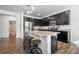 Kitchen island with bar stools, granite countertops, and stainless steel appliances, with adjacent dining area at 4604 Copeland Cir # 101, Highlands Ranch, CO 80126