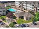 Aerial view of community pool, spa, clubhouse and apartment buildings with parking at 15700 E Jamison Dr # 8-208, Englewood, CO 80112