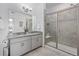 A modern bathroom featuring a double vanity, gray cabinets, and glass-enclosed shower at 15700 E Jamison Dr # 8-208, Englewood, CO 80112