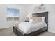 A serene bedroom with neutral tones, carpeted floors, and natural light at 15700 E Jamison Dr # 8-208, Englewood, CO 80112