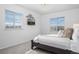 A bright bedroom with light-colored walls, carpet, and two windows at 15700 E Jamison Dr # 8-208, Englewood, CO 80112