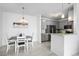 Bright dining area with adjacent kitchen, featuring modern appliances and stylish decor at 15700 E Jamison Dr # 8-208, Englewood, CO 80112