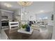 Open concept living, dining, and kitchen areas featuring natural light, stylish decor, and modern fixtures at 15700 E Jamison Dr # 8-208, Englewood, CO 80112