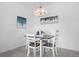 A cozy dining area featuring a modern chandelier and seating for four at 15700 E Jamison Dr # 8-208, Englewood, CO 80112