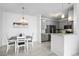 Contemporary dining area adjacent to a modern kitchen with gray cabinetry and stainless steel appliances at 15700 E Jamison Dr # 8-208, Englewood, CO 80112