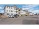 Exterior view of complex buildings featuring light gray siding, balconies, and well-maintained landscaping at 15700 E Jamison Dr # 8-208, Englewood, CO 80112