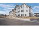 Attractive apartment complex showcasing a well-maintained exterior with neutral siding and dark shutters at 15700 E Jamison Dr # 8-208, Englewood, CO 80112