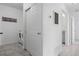 Hallway with laundry machines, closet, and view into bathroom featuring tile flooring at 15700 E Jamison Dr # 8-208, Englewood, CO 80112