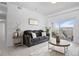 Bright living room featuring comfortable seating, stylish decor, and a sliding door to the balcony at 15700 E Jamison Dr # 8-208, Englewood, CO 80112