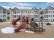 Community playground with slides and other activities in front of apartment complex in winter at 15700 E Jamison Dr # 8-208, Englewood, CO 80112