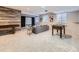 Spacious basement area with entertainment area, games, projector screen, and wood accent wall at 1020 S Ammons Cir, Lakewood, CO 80226