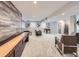 Wide open finished basement with shuffleboard, projector, and seating area at 1020 S Ammons Cir, Lakewood, CO 80226