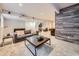 Spacious finished basement featuring a large sofa, movie projector, and accent wall at 1020 S Ammons Cir, Lakewood, CO 80226