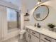 Bright bathroom featuring a shower, tub, and vanity with ample storage space at 1020 S Ammons Cir, Lakewood, CO 80226