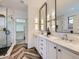 Elegant bathroom with dual sinks, framed mirrors, and a glass-enclosed shower at 1020 S Ammons Cir, Lakewood, CO 80226