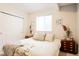 Cozy bedroom featuring plush bedding, soft lighting, and closet at 1020 S Ammons Cir, Lakewood, CO 80226