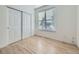 Bright bedroom features a window with blinds, a large closet with sliding doors, and light wood flooring at 1020 S Ammons Cir, Lakewood, CO 80226