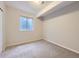 Neutral bedroom features a small window with privacy glass and neutral carpet at 1020 S Ammons Cir, Lakewood, CO 80226