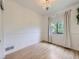 Bright bedroom with hardwood floors, natural light, and a modern chandelier, creating a cozy and inviting atmosphere at 1020 S Ammons Cir, Lakewood, CO 80226