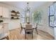 Bright breakfast nook featuring natural light, floating shelves, and contemporary furnishings at 1020 S Ammons Cir, Lakewood, CO 80226