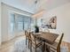 Elegant dining room with a modern chandelier, a large window, and stylish decor at 1020 S Ammons Cir, Lakewood, CO 80226