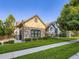 Well-manicured front yard of a charming home with a stone facade and three-car garage at 1020 S Ammons Cir, Lakewood, CO 80226