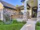 Inviting front porch with stone pillars and manicured landscaping at entrance of home at 1020 S Ammons Cir, Lakewood, CO 80226