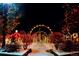 Festive holiday display with colorful lights adorning trees and pathways in a snowy setting at 1020 S Ammons Cir, Lakewood, CO 80226