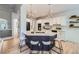 Modern kitchen with a large island, white cabinetry, stainless steel appliances, and pendant lighting at 1020 S Ammons Cir, Lakewood, CO 80226