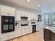 Well-appointed kitchen features white cabinets, stainless steel appliances, and modern fixtures at 1020 S Ammons Cir, Lakewood, CO 80226
