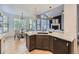 Open kitchen and dining area with modern lighting, an island, and stainless steel appliances at 1020 S Ammons Cir, Lakewood, CO 80226