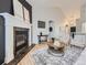 Bright living room with hardwood floors, fireplace, and vaulted ceilings for a spacious and inviting feel at 1020 S Ammons Cir, Lakewood, CO 80226