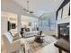 Inviting living room with a cozy fireplace, large windows, vaulted ceilings and an adjacent kitchen at 1020 S Ammons Cir, Lakewood, CO 80226