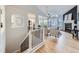 Open-concept living space with hardwood floors, fireplace, and a view of the modern kitchen at 1020 S Ammons Cir, Lakewood, CO 80226