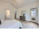 Main bedroom with neutral tones, backyard access, and an ensuite bathroom at 1020 S Ammons Cir, Lakewood, CO 80226