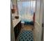 Functional bathroom with a shower, vanity, and blue-patterned shower curtain at 3173 Youngheart Way, Castle Rock, CO 80109