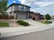 Two-story home featuring a large driveway, two car garage, and manicured landscaping at 3173 Youngheart Way, Castle Rock, CO 80109