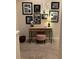 Cozy home office nook with a wooden desk, pink stool, and gallery wall adorned with Gathering photos at 3173 Youngheart Way, Castle Rock, CO 80109