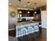 Charming kitchen featuring dark cabinets, granite counters, stainless steel appliances, and a kitchen island at 3173 Youngheart Way, Castle Rock, CO 80109