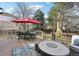 Outdoor deck with ample seating, a fire pit, and a red umbrella for shade on a sunny day at 11623 E Ida Ave, Englewood, CO 80111