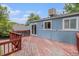 Backyard deck with wood railing attached to a home with an attractive blue exterior at 4678 S Lewiston Way, Aurora, CO 80015