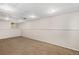 Finished basement area with neutral carpet, paneled walls, and recessed lighting at 4678 S Lewiston Way, Aurora, CO 80015