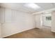 Finished basement area with neutral carpet, paneled walls, and recessed lighting at 4678 S Lewiston Way, Aurora, CO 80015