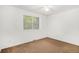 Bright bedroom with neutral walls, carpet flooring, and a large window providing natural light at 4678 S Lewiston Way, Aurora, CO 80015