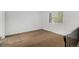 Bright bedroom with neutral walls, carpet flooring, and a large window providing natural light at 4678 S Lewiston Way, Aurora, CO 80015