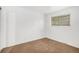 Bright bedroom with neutral walls, carpet flooring, and a large window providing natural light at 4678 S Lewiston Way, Aurora, CO 80015